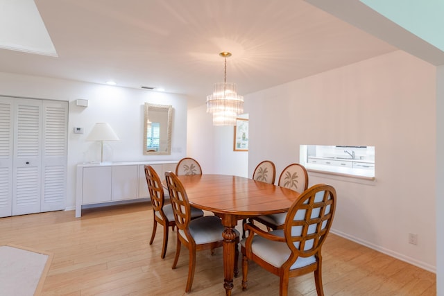 dining room featuring a chandelier and light wood-type flooring