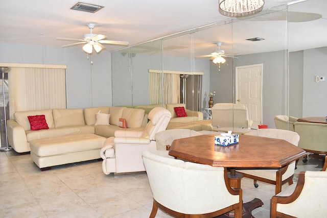 interior space featuring ceiling fan with notable chandelier