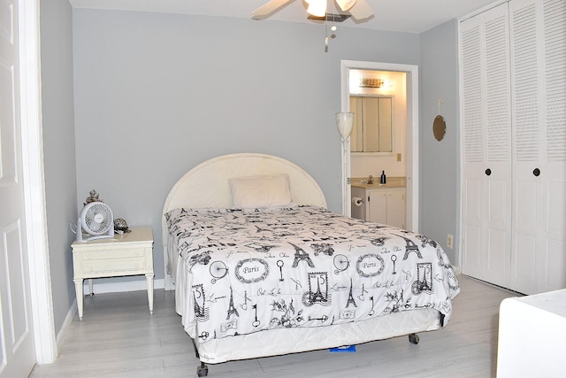 bedroom with light hardwood / wood-style flooring, ceiling fan, ensuite bathroom, and a closet