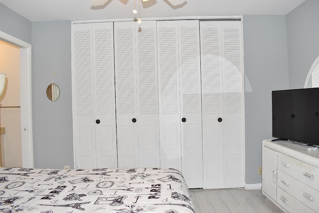 bedroom with ceiling fan and light hardwood / wood-style flooring