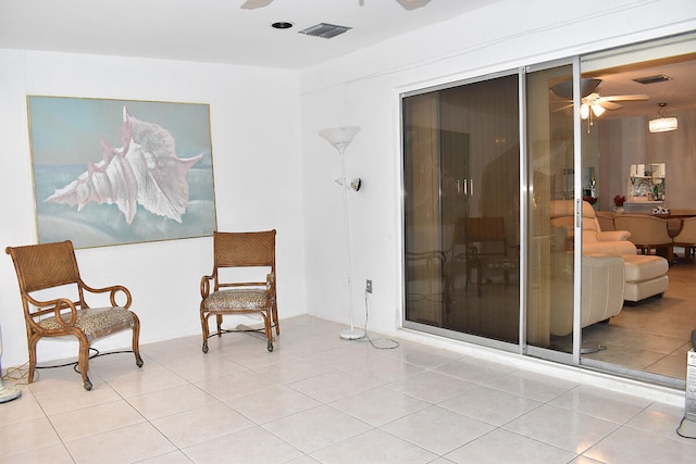 sitting room featuring ceiling fan and light tile patterned flooring