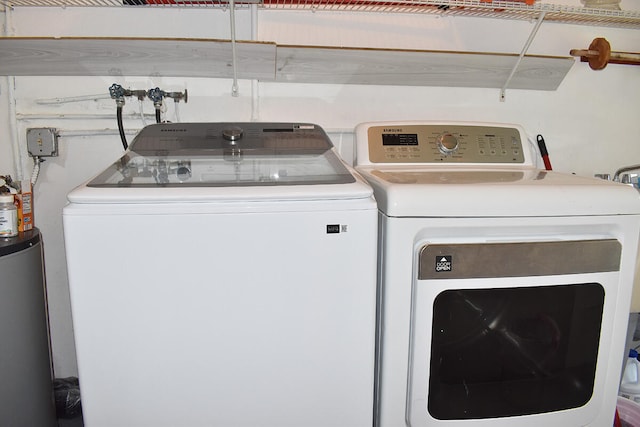 washroom featuring separate washer and dryer and water heater