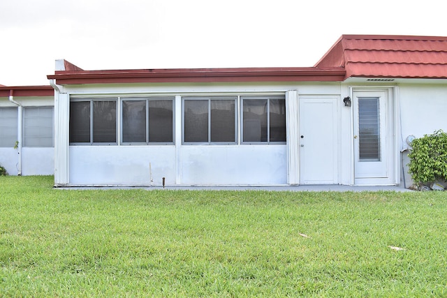 rear view of house with a yard