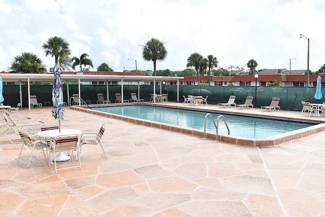 view of swimming pool featuring a patio area