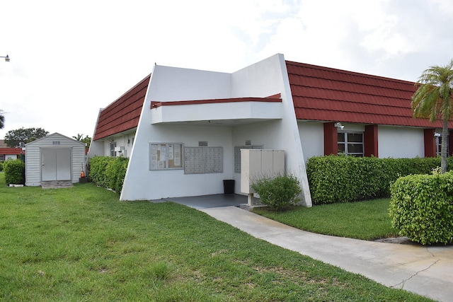 view of front facade with a front lawn and a shed