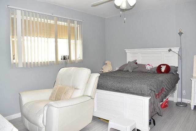 bedroom with light hardwood / wood-style floors and ceiling fan