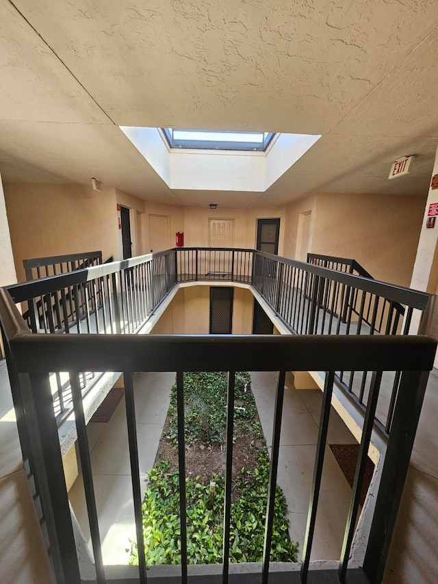 staircase featuring a skylight and a healthy amount of sunlight