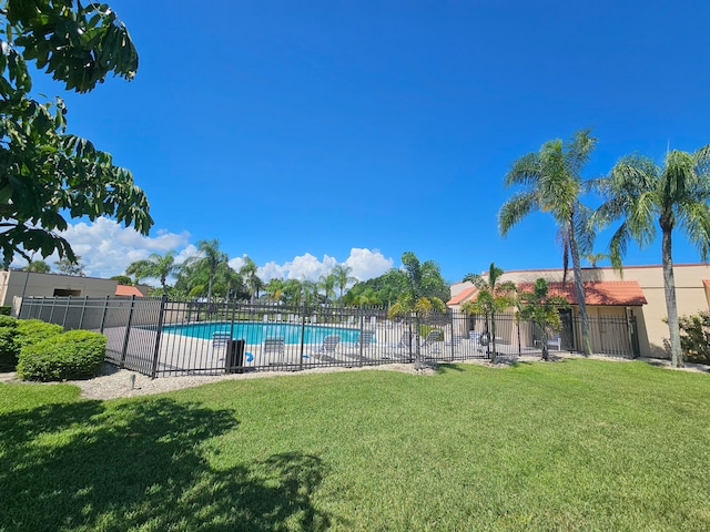 view of swimming pool with a lawn