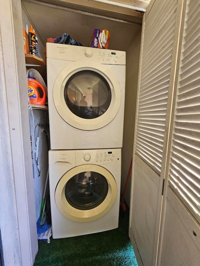 clothes washing area featuring stacked washer / drying machine