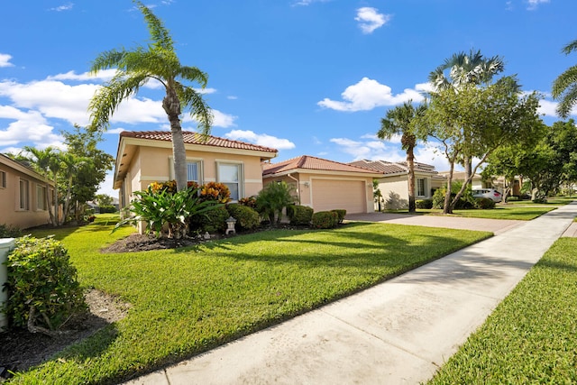 mediterranean / spanish-style home featuring a front lawn and a garage