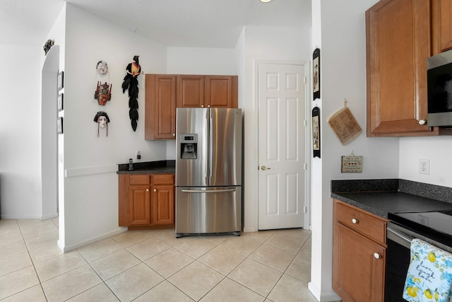 kitchen with appliances with stainless steel finishes and light tile patterned floors