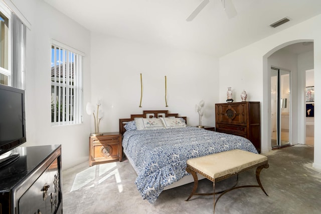 bedroom with a closet, connected bathroom, and ceiling fan