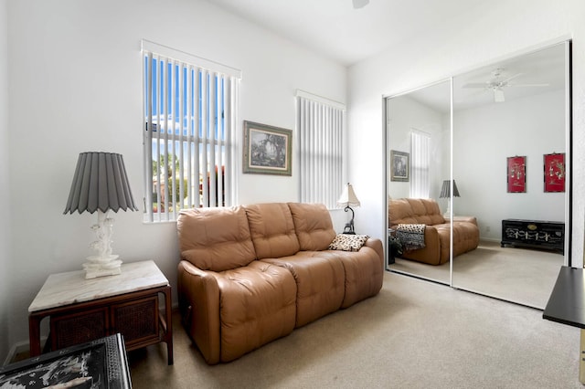 carpeted living room with ceiling fan