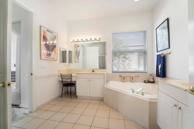 bathroom with vanity, a relaxing tiled tub, and tile patterned floors