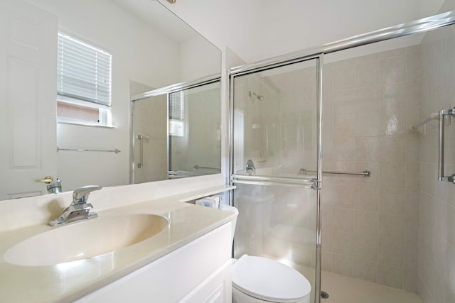 bathroom with vanity, toilet, and an enclosed shower