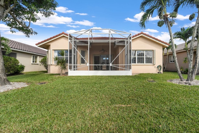 back of property featuring a lawn and glass enclosure