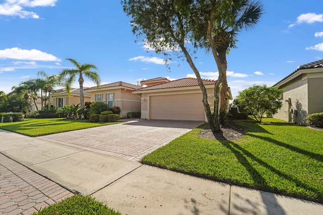 view of front of property with a garage and a front lawn