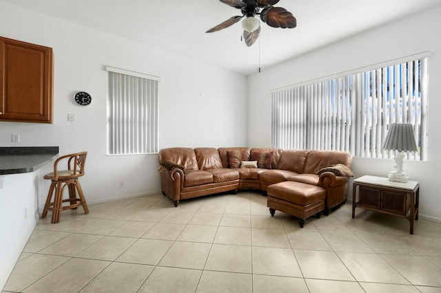 tiled living room featuring ceiling fan