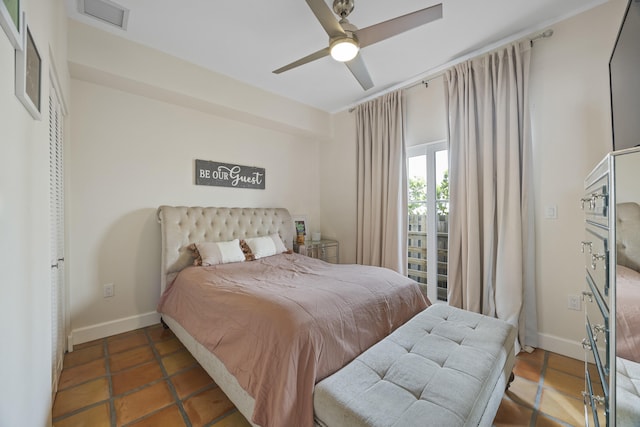 bedroom featuring dark tile patterned floors and ceiling fan