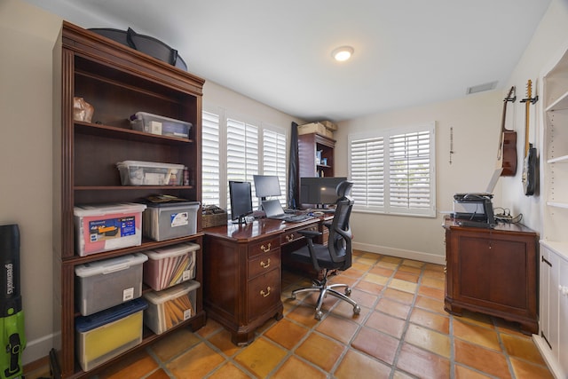 tiled office with a healthy amount of sunlight