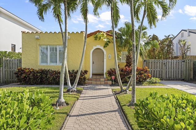 mediterranean / spanish home featuring a front yard