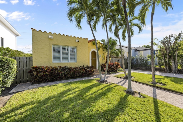 mediterranean / spanish home featuring a front lawn