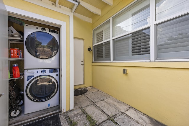 laundry area with stacked washer / dryer