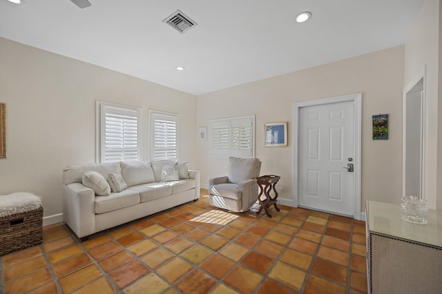 living room with ceiling fan and tile patterned flooring