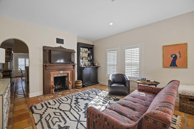 tiled living room featuring a fireplace