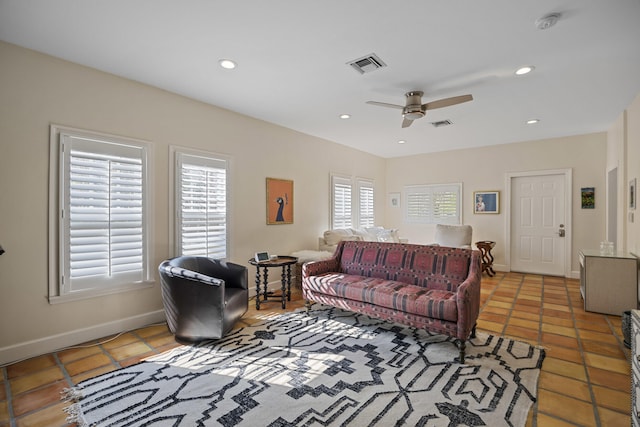 tiled living room with a healthy amount of sunlight and ceiling fan