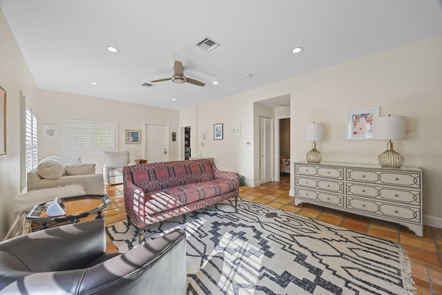 living room with ceiling fan and light tile patterned flooring