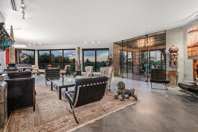 living room with concrete flooring and track lighting