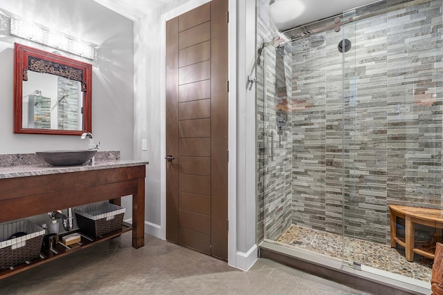 bathroom with concrete flooring, vanity, and walk in shower