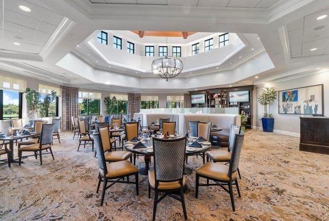 dining room with coffered ceiling, ornamental molding, and a chandelier