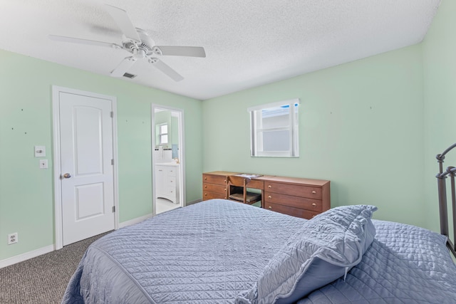 carpeted bedroom featuring connected bathroom, ceiling fan, and a textured ceiling