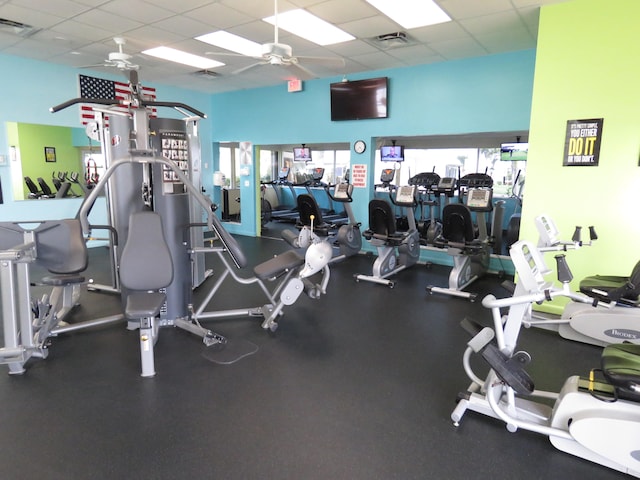 gym with a drop ceiling and ceiling fan