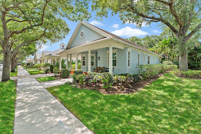 view of home's exterior with a porch and a yard