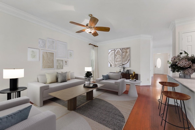 living room featuring ceiling fan, light wood-type flooring, and crown molding