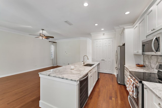 kitchen with sink, beverage cooler, a kitchen island with sink, white cabinetry, and stainless steel appliances