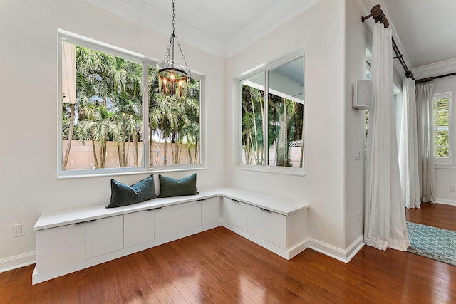 interior space featuring ornamental molding, an inviting chandelier, and dark wood-type flooring