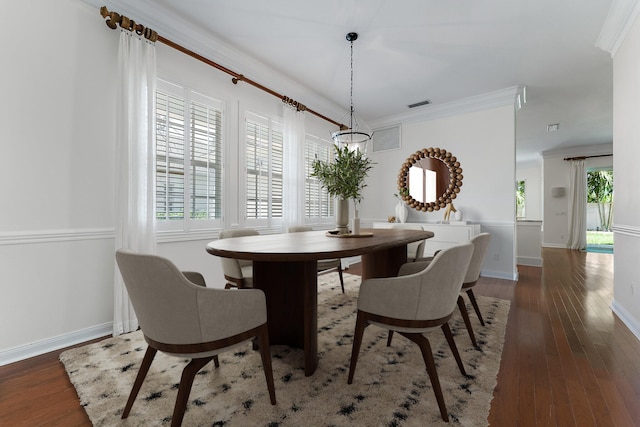 dining area with crown molding and dark hardwood / wood-style floors