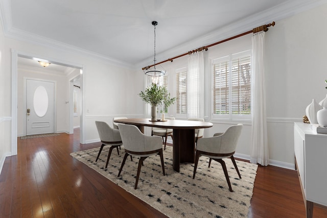 dining space featuring ornamental molding, dark hardwood / wood-style floors, and a chandelier