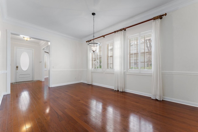 unfurnished dining area with ornamental molding, a notable chandelier, and dark hardwood / wood-style floors