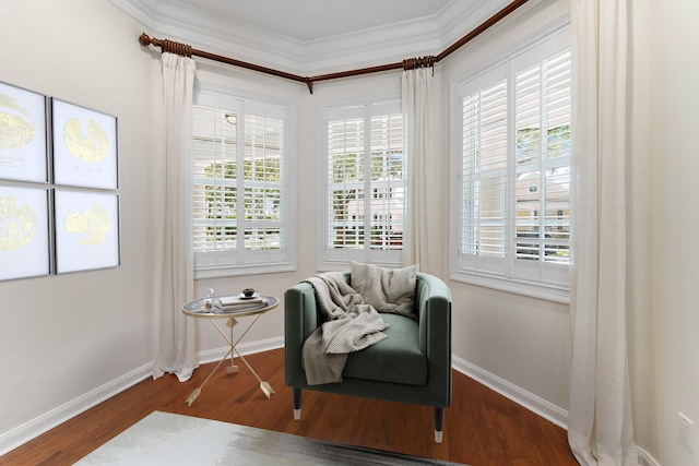 sitting room with a wealth of natural light, dark wood-type flooring, and crown molding