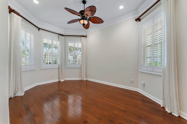 empty room featuring ornamental molding, dark hardwood / wood-style flooring, ceiling fan, and a wealth of natural light