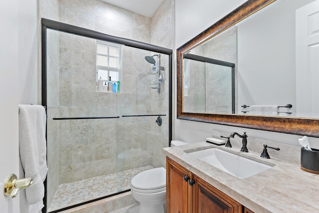 bathroom with vanity, toilet, and an enclosed shower