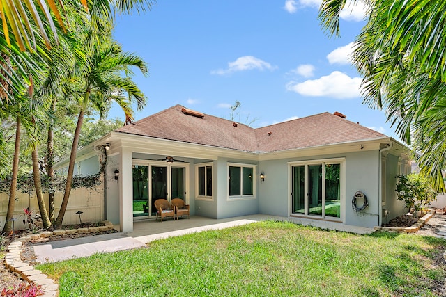 rear view of house with a lawn, a patio, and ceiling fan