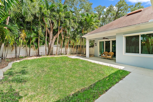 view of yard featuring ceiling fan and a patio area