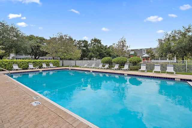 view of pool featuring a yard