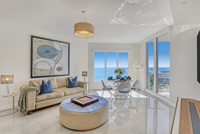 living room featuring a wealth of natural light and a water view